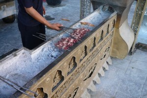 A Uyghur vendor makes lamb kebabs in Xinjiang