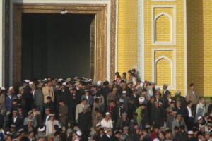 Uygur men exit Kashgar's Id Kah Mosque after prayer
