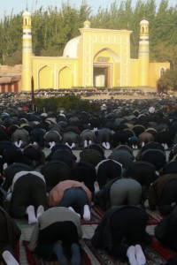 Uygur men pray at the Id Kah Mosque in Kashgar