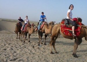 Riding a camel in Xinjiang's Taklamakan Desert