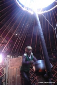 A Kyrgyk woman prepares dinner in a yurt (ger)