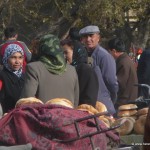 Uyghur people wander around a Friday market in Xinjiang