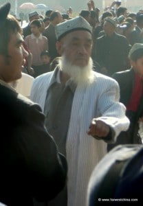 An old Uyghur man dancing in the town square
