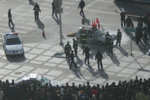 Car sits in a Beijing street after people self-immolate inside
