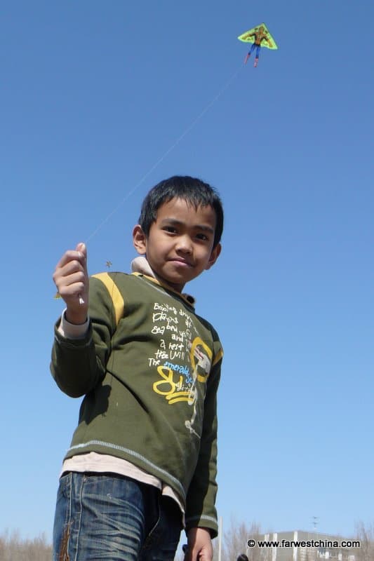 Xinjiang kite flying A kid flies a kite in beautiful Xinjiang, China