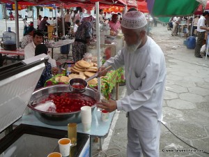 A Uyghur man serves food at a Muslim Market in Xinjiang