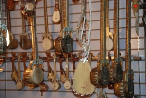 Uyghur musical instruments hanging in a market