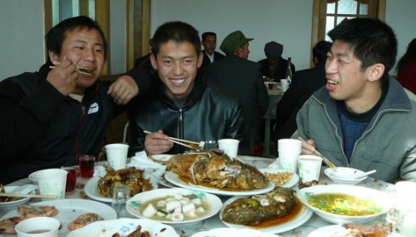 Chinese banquet Three men at a Chinese banquet. Eating or talking?