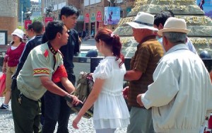 Police check bags of visitors in Urumqi