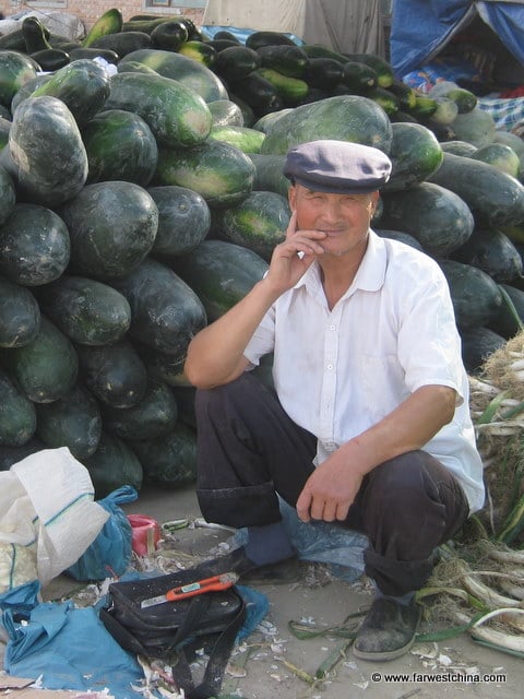 A Uyghur man selling watermelon in Xinjiang