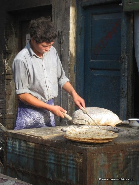 A Uygur man making flat Uyghur bread