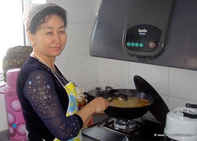 A Uyghur woman cooking at home