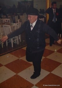 An old man doing a Uyghur dance at a wedding