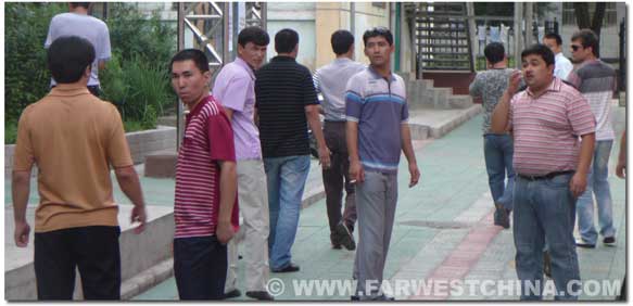 Uyghur men exiting the housing community