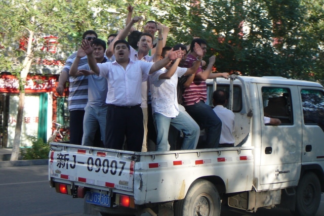 A truck full of Uyghur men celebrating a wedding via the parade