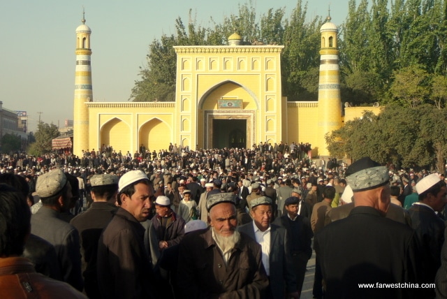 Uyghur men exit Kashgar's Id Kah mosque after prayers