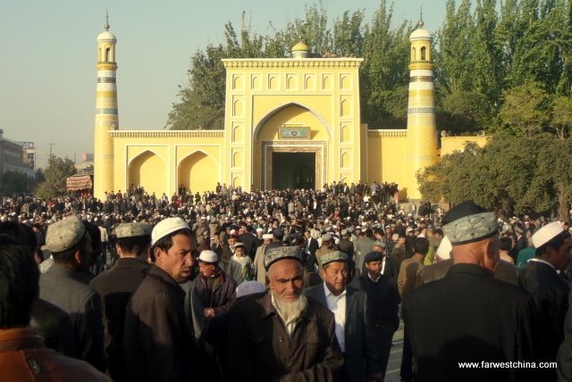 Uyghur men exit Kashgar's Id Kah mosque after prayers