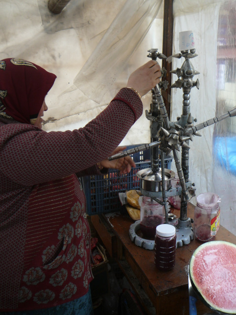 A vendor squeezes pomegranate juice in Xinjiang