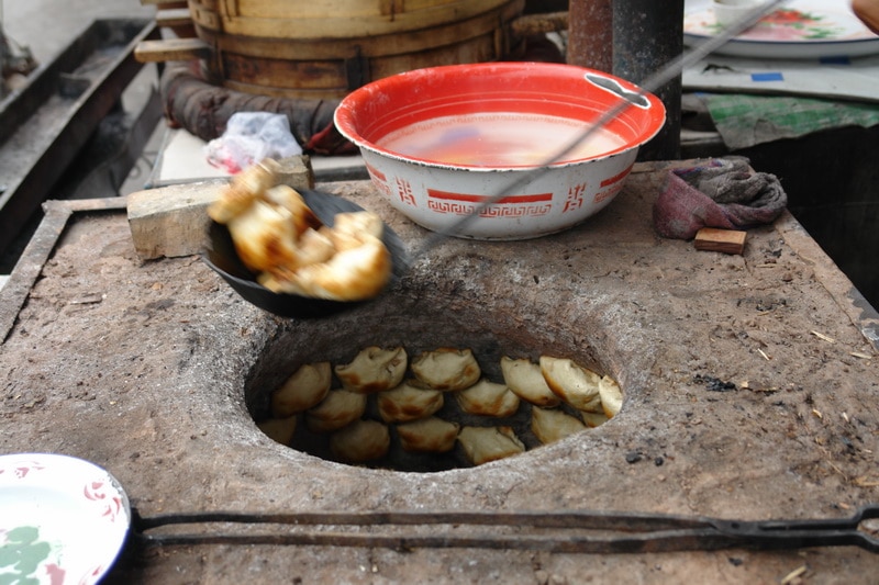 Samsa cooking in a Uyghur oven in Xinjiang, China