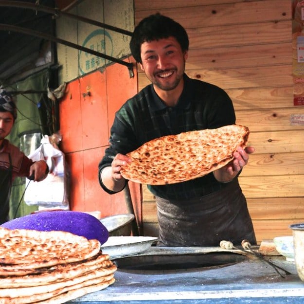 A Uyghur man in Xinjiang, China is all smiles