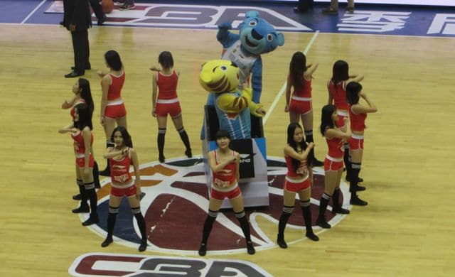 Dancers and mascots dance during a CBA game in Urumqi, Xinjiang