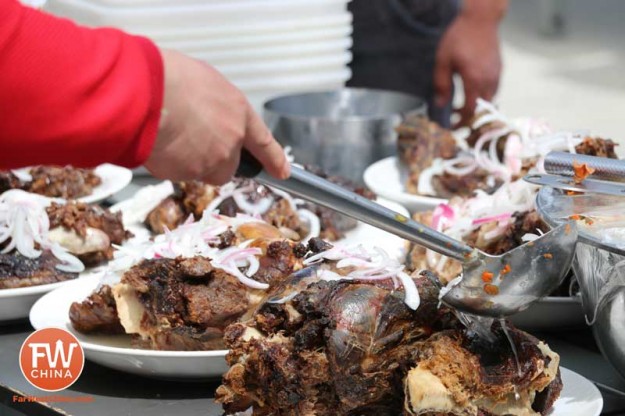 During a Kazakh Newruz celebration, smoked lamb meat is served