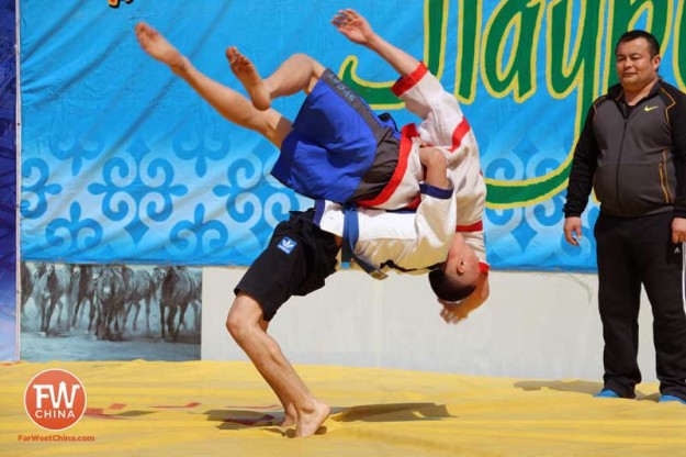 A man gets thrown to the ground during a Kazakh wrestling match