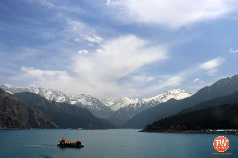 A beautiful view of Xinjiang's Heavenly Lake with a boat
