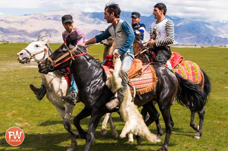 Buzkashi riders carry the goat carcass "ball"