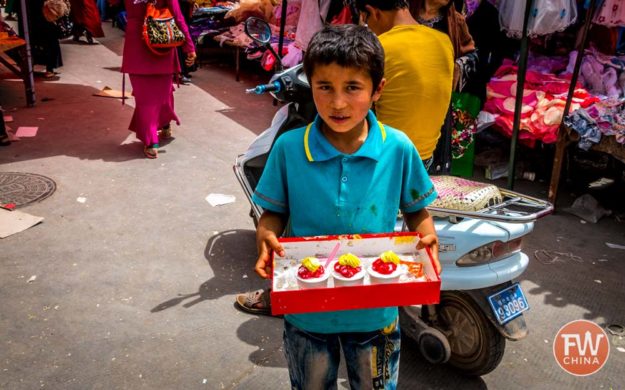 Young Uyghur seller at the market