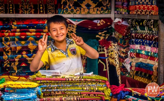 Uyghur boy smiles for the camera in Kashgar, Xinjiang