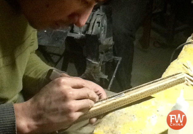 Uyghur craftsman making a dutar