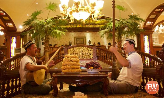 Two Uyghur playing dutars in a restaurant in Kashgar, Xinjiang