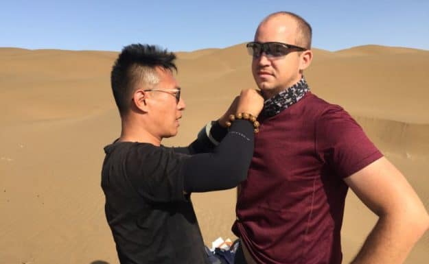 Getting mic'ed up by CCTV crew at the Shanshan sand dunes