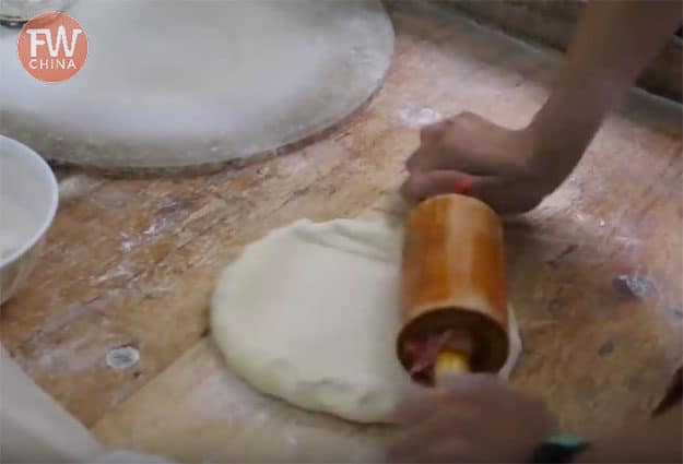 Rolling out the Uyghur dough mixture